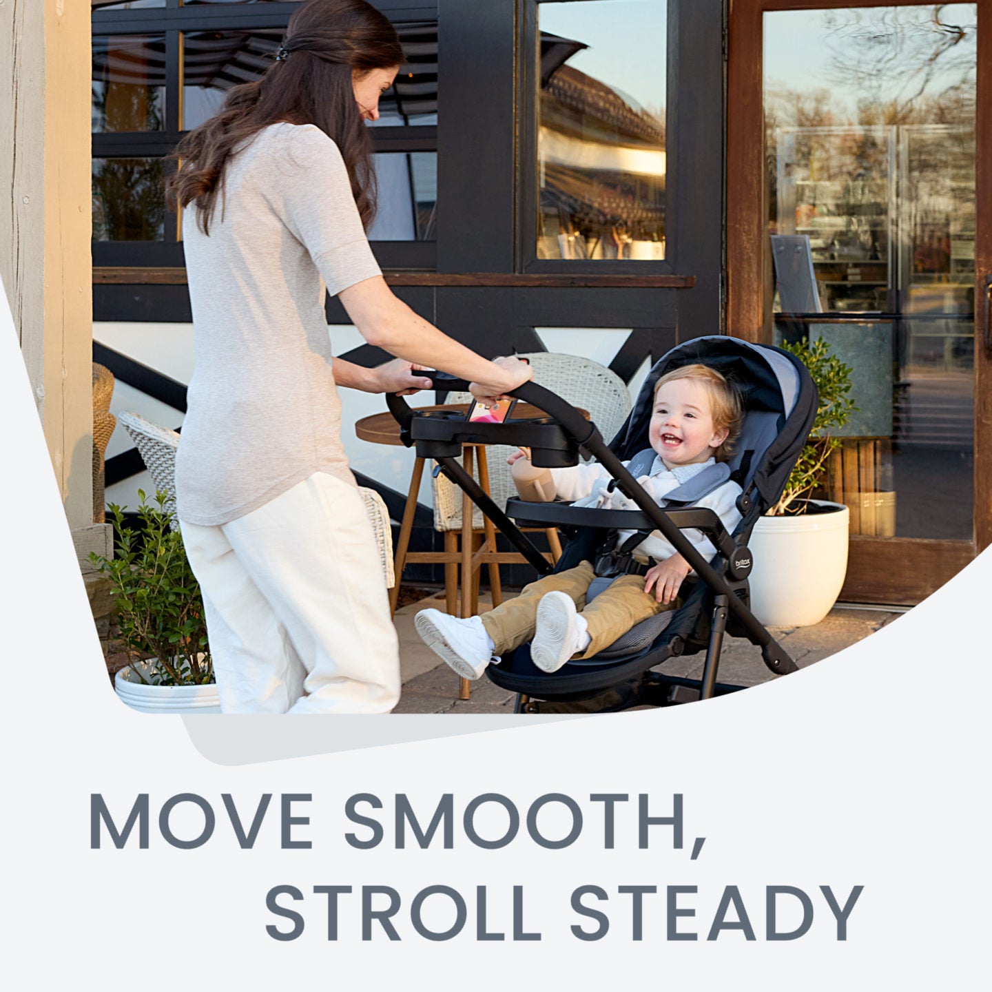 Mom pushing baby in Britax Brook+ Stroller - Graphite Onyx