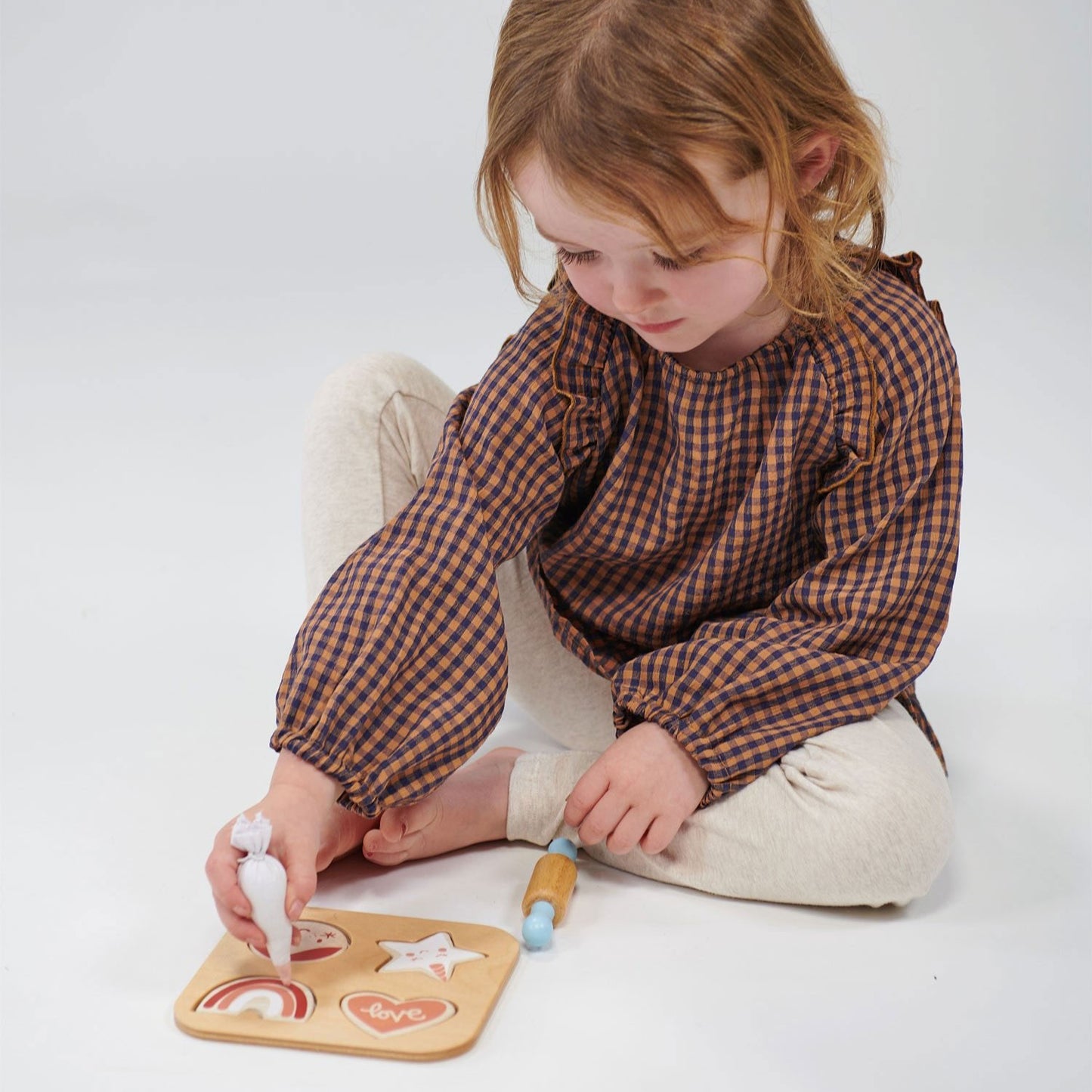 Child plays with Mentari Toys Cookie Cutting Set