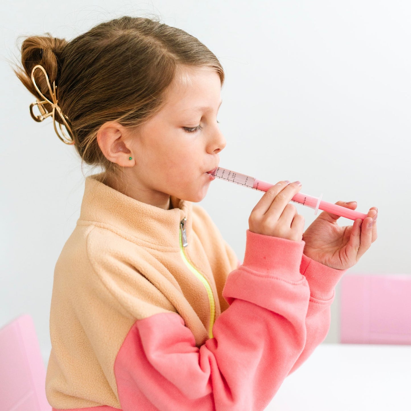 Girl takes medicine using Ryan and Rose Cutie Dose - Oral Liquid Dispenser - Lollipop