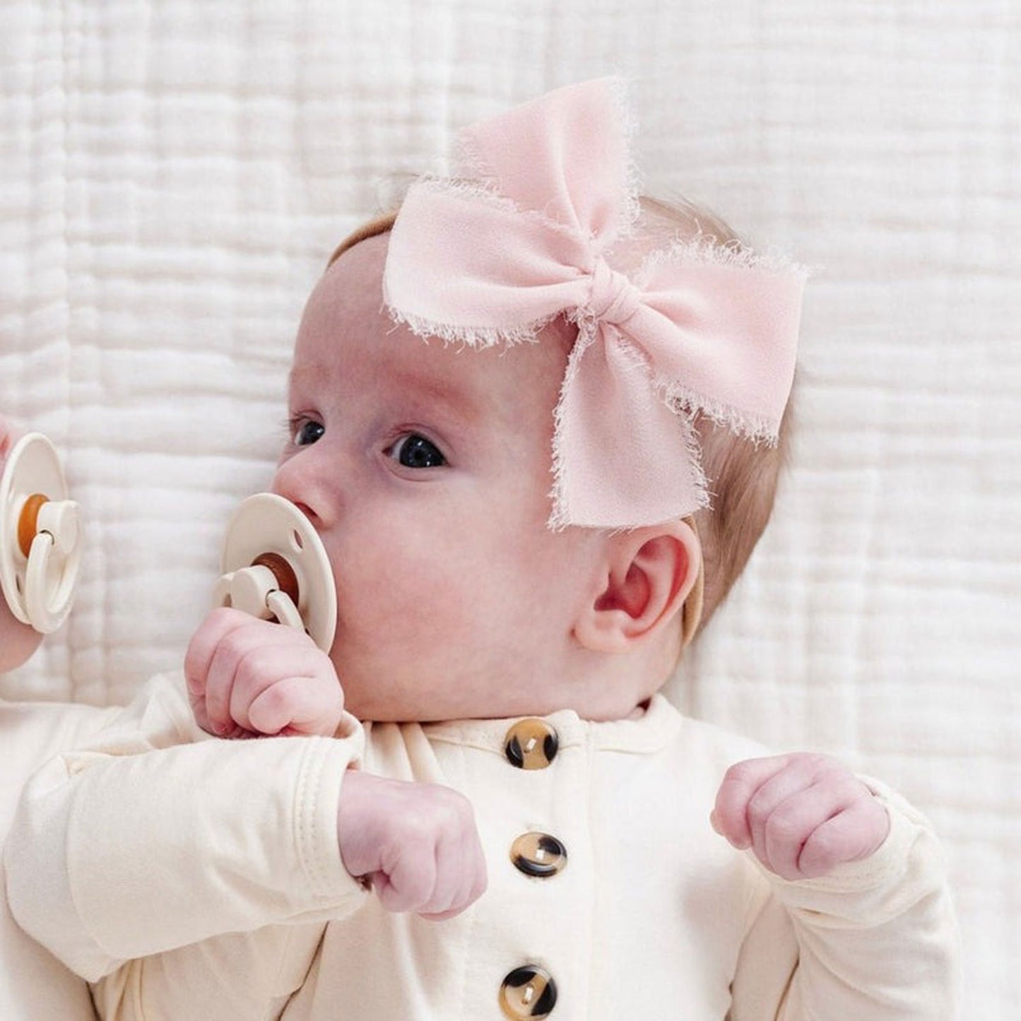 Baby wearing Lou Lou and Company Chiffon Bow Headband - Blush