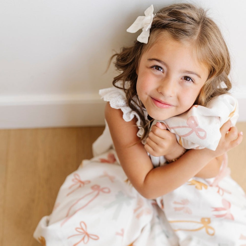Little girl snuggles Saranoni Receiving Minky / Lush Blanket - Bows