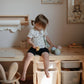 Little girl plays with Mushie Mix and Match Cupcake Toy - Original