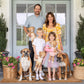 Jillian Harris's family standing in front of home while son holds Cuddle and Kind George the Dog