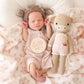 Newborn baby lying next to Cuddle and Kind Ava the Cow - Powder Pink