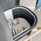 Baby lying in bassinet on top of UPPAbaby New Bassinet Mattress Cover - White