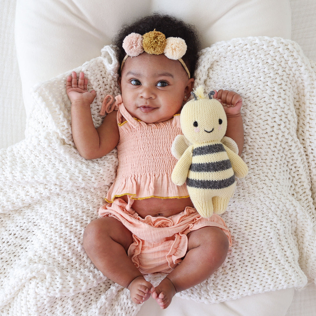 Baby girl holding Cuddle and Kind Baby Bee - Yellow
