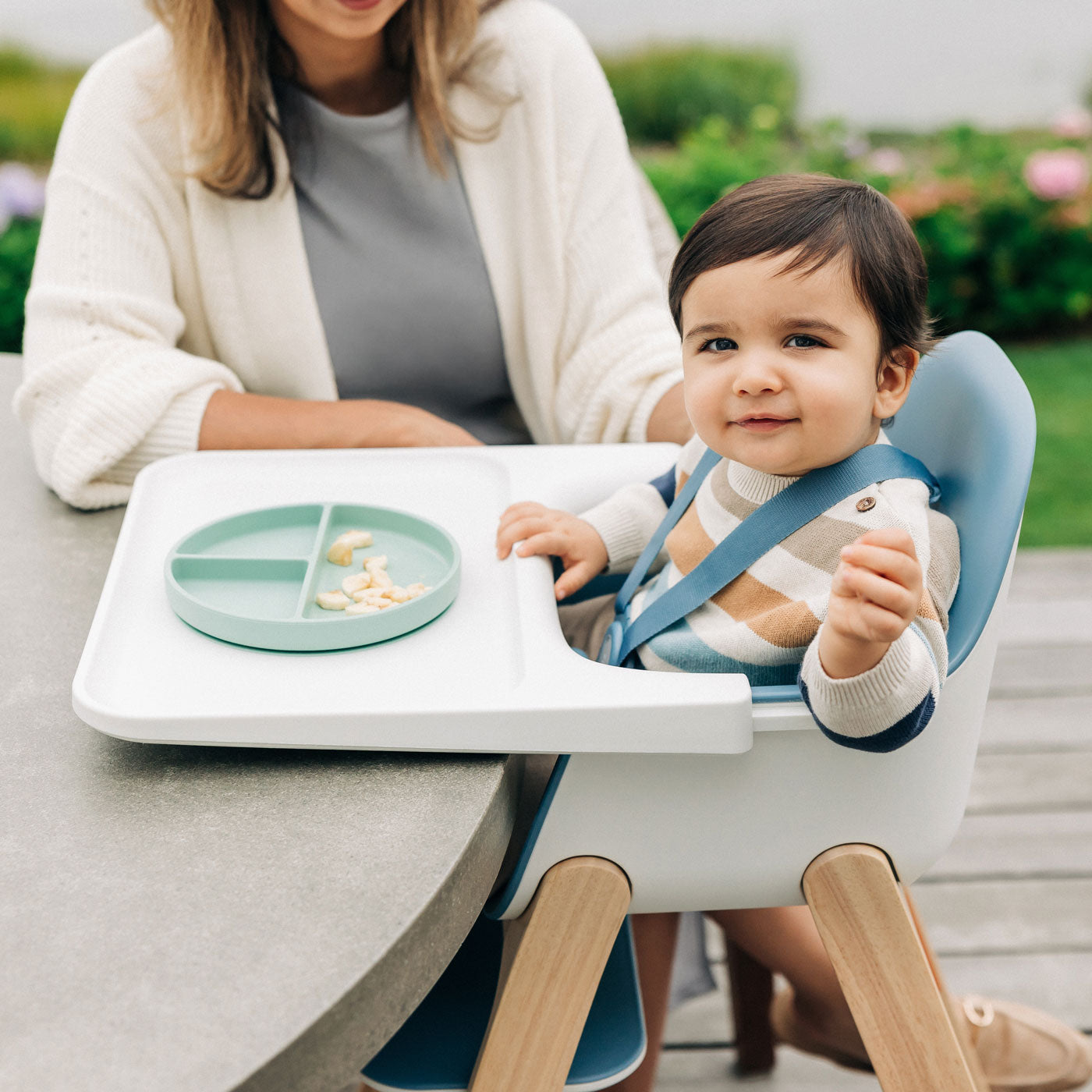 Baby sitting in UPPAbaby CIRO High chair - CALEB (Steel Blue) outside