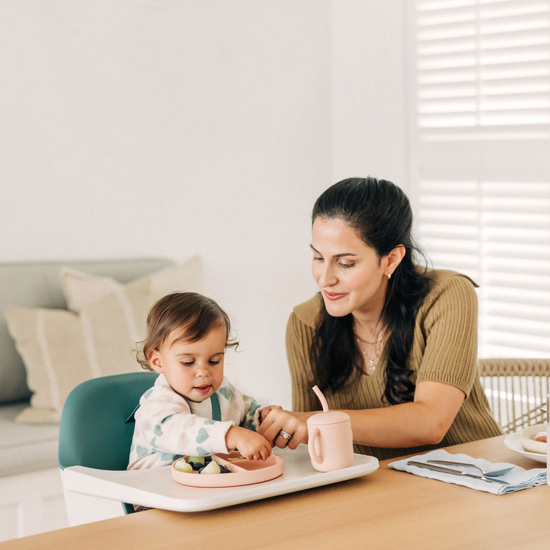 Mom feeding baby sitting in UPPAbaby CIRO High Chair - EMRICK (Spruce Green)