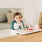 Baby eating food while sitting in UPPAbaby CIRO High Chair - EMRICK (Spruce Green)