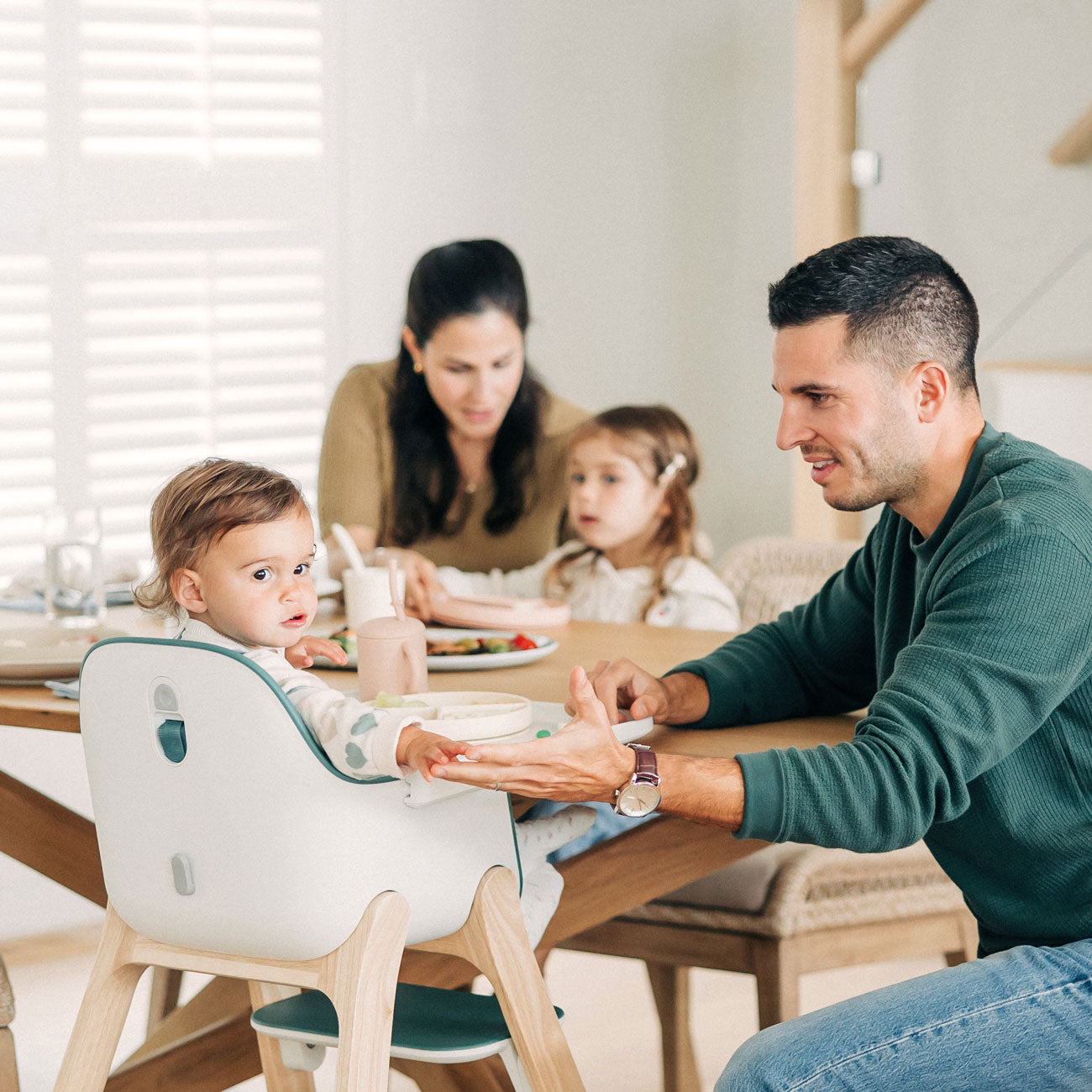 Dad smiling at baby sitting in UPPAbaby CIRO High Chair - EMRICK (Spruce Green)