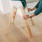 Dad adjusting footrest of UPPAbaby CIRO High chair - EMRICK (Spruce Green)