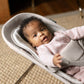 Baby girl sitting in UPPAbaby MIRA 2-in-1 Bouncer and Seat - CHARLIE (Sand Melange)