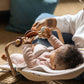 Baby sitting in MIRA bouncer playing with UPPAbaby Wonder Wheel Toy Bar - MIRA accessory attached
