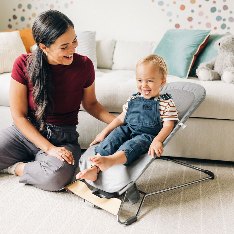 Toddler sitting in UPPAbaby MIRA 2-in-1 Bouncer and Seat - STELLA (Grey Melange)