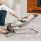 Dad looking at baby sitting in UPPAbaby MIRA 2-in-1 Bouncer and Seat - WELLS (Dark Taupe Melange)