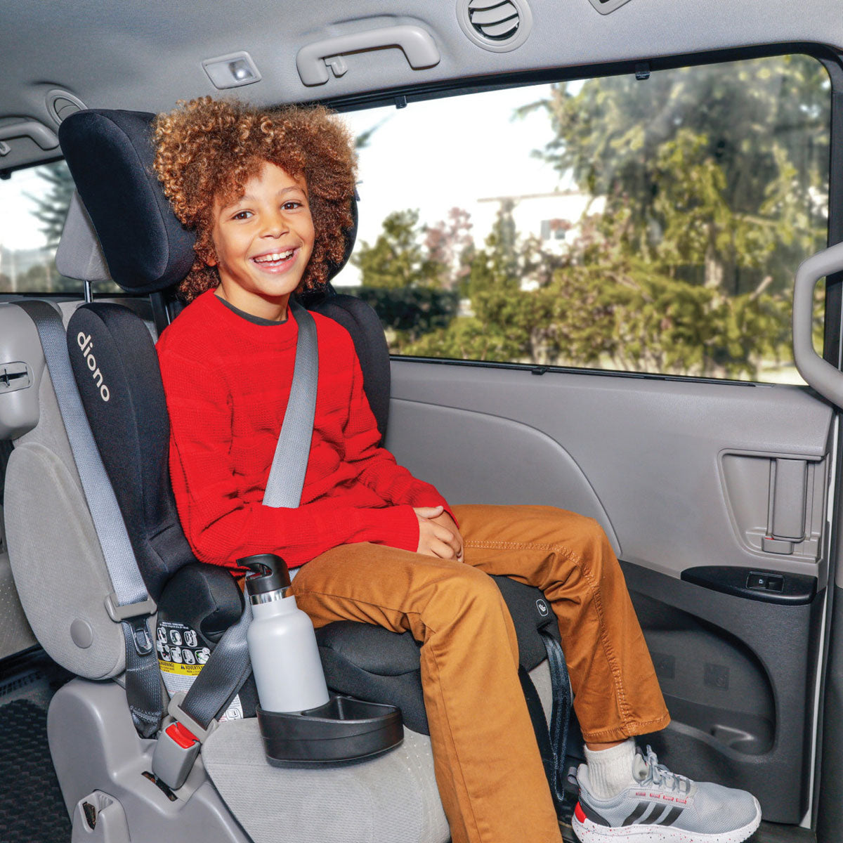 Child sitting in vehicle in Diono Cambria 2XT Booster Car Seat - Black Storm