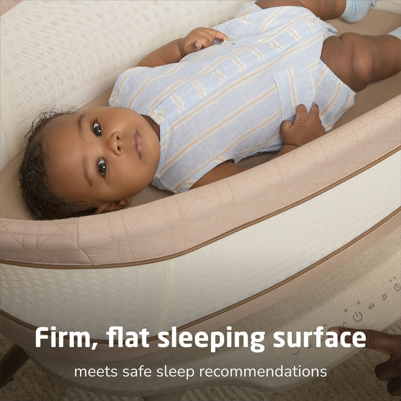 Baby lying in Maxi-Cosi Starling Smart Bassinet - Natural Heritage
