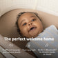 Baby lying in Maxi-Cosi Starling Smart Bassinet - Natural Heritage