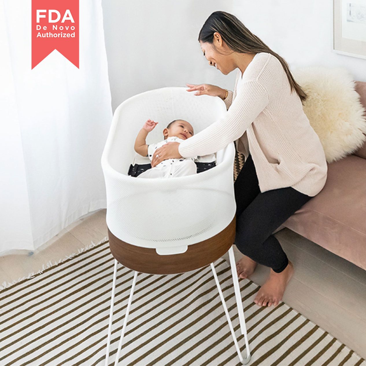 woman with baby in Happiest Baby SNOO Smart Sleeper - White