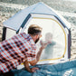 Dad looks at baby inside playard of Veer Basecamp Bundle - Basecamp / Air Pad / Adventure Tote - White / Gray