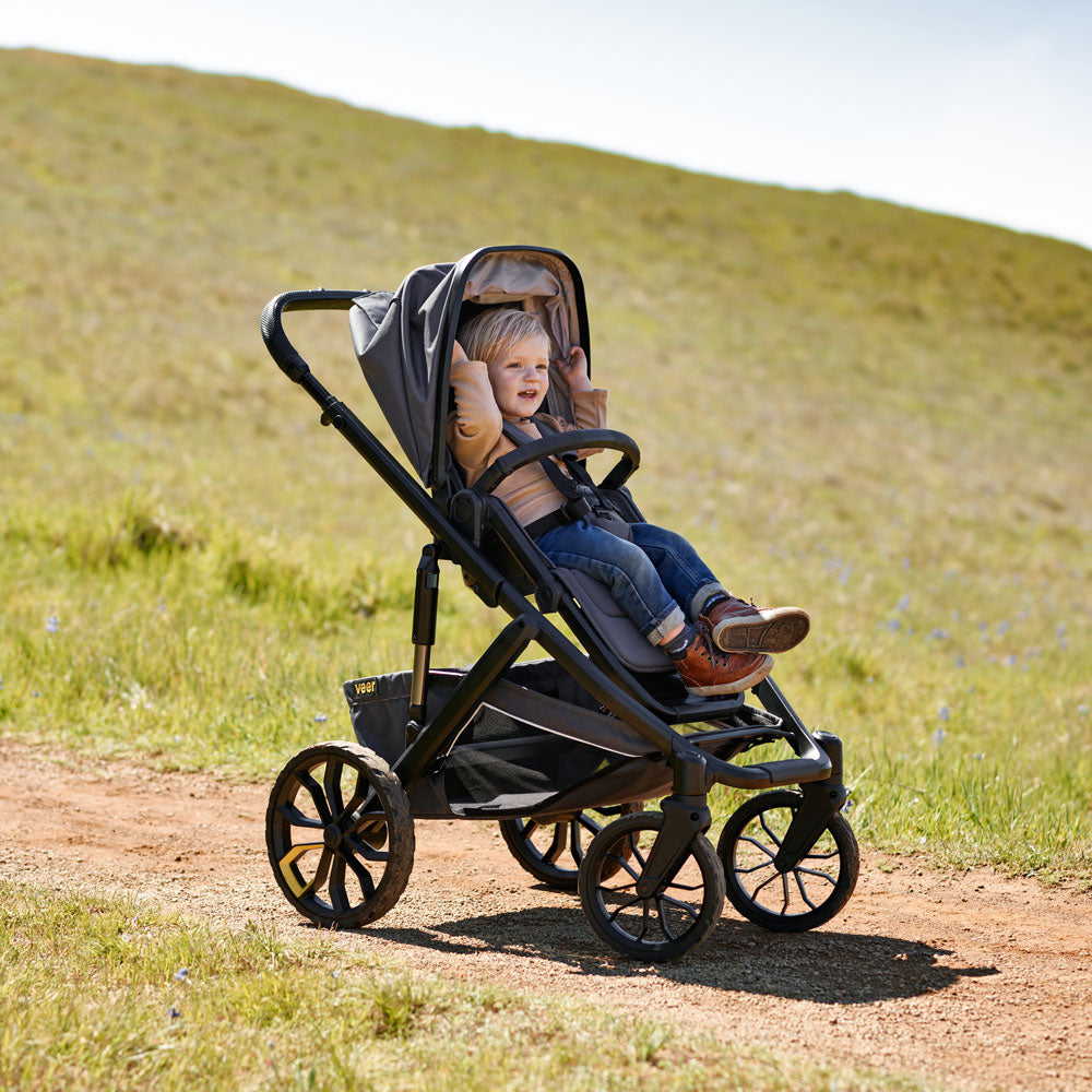 Toddler rides in Veer Switchback / &Roll Stroller Frame