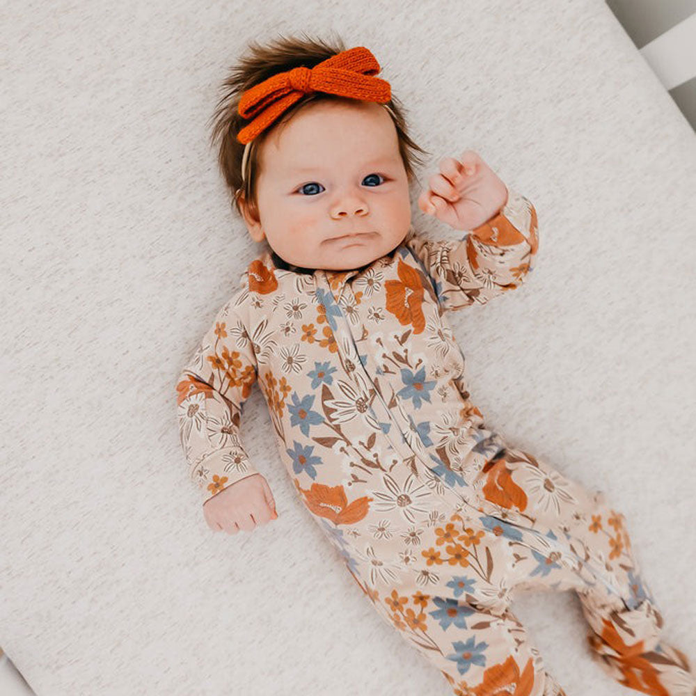 Baby girl wearing Copper Pearl Zip-up Footie - Eden