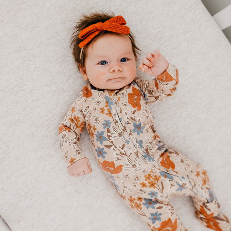 Baby girl wearing Copper Pearl Zip-up Footie - Eden