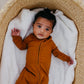 Baby wearing Copper Pearl Zip-up Footie - Camel