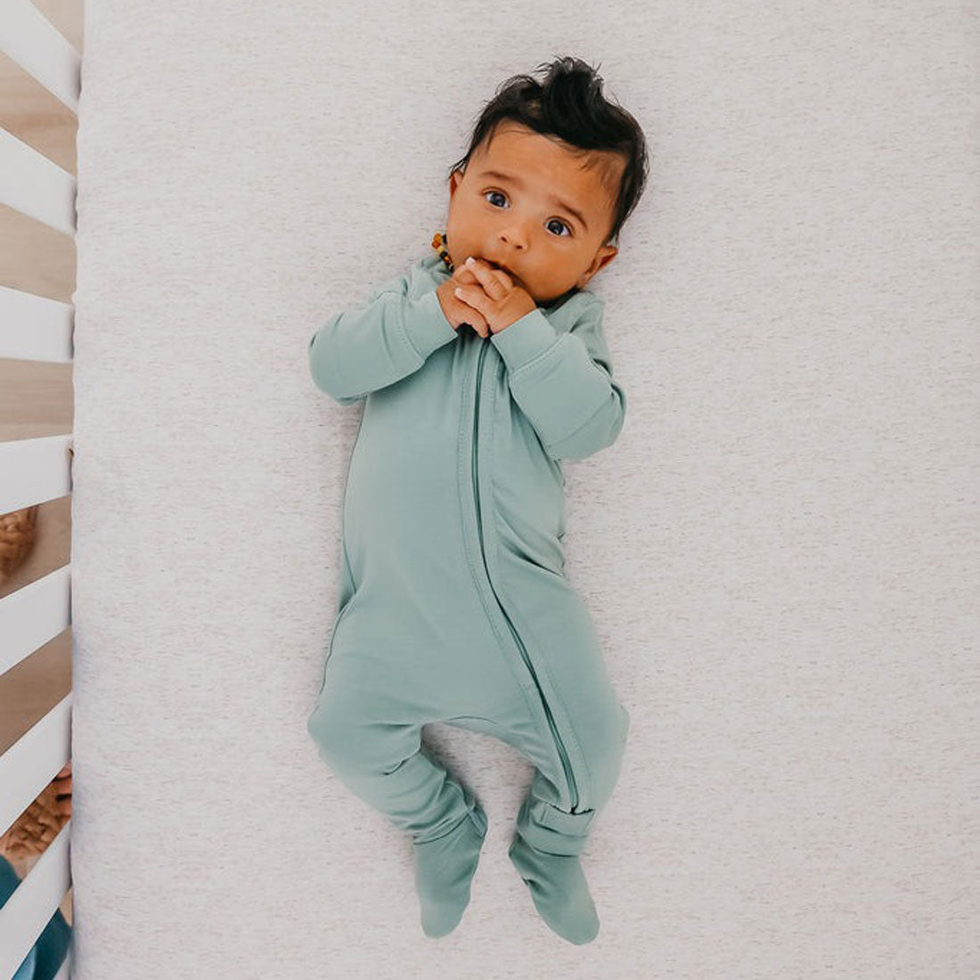 Baby wearing Copper Pearl Zip-up Footie - Briar