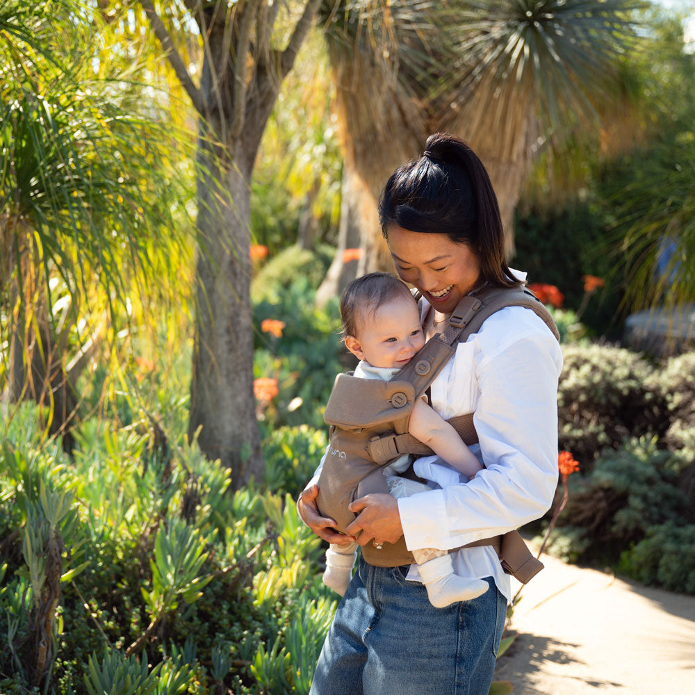 Mom carrying baby in Nuna CUDL Luxe Carrier - Canyon
