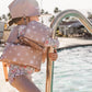 Girl at swimming pool wearing Current Tyed Clothing Swim Floaties - Gold Suns