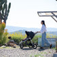 Mom pushes child in Bumbleride 2024 Indie All Terrain Stroller - Dusk