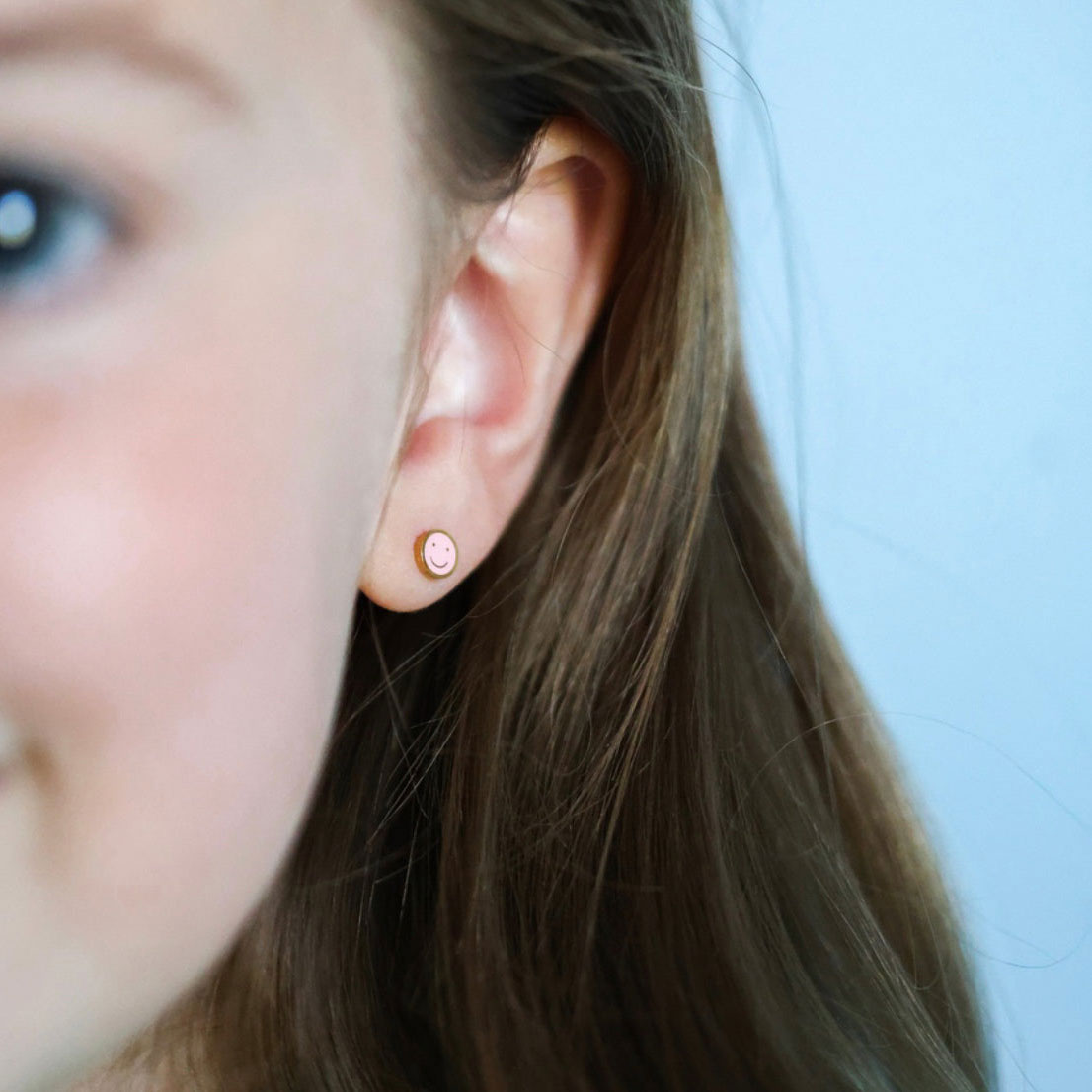 Little girl wearing Pierced Co Tiny Smiley Screw Back Child Earrings - Pink