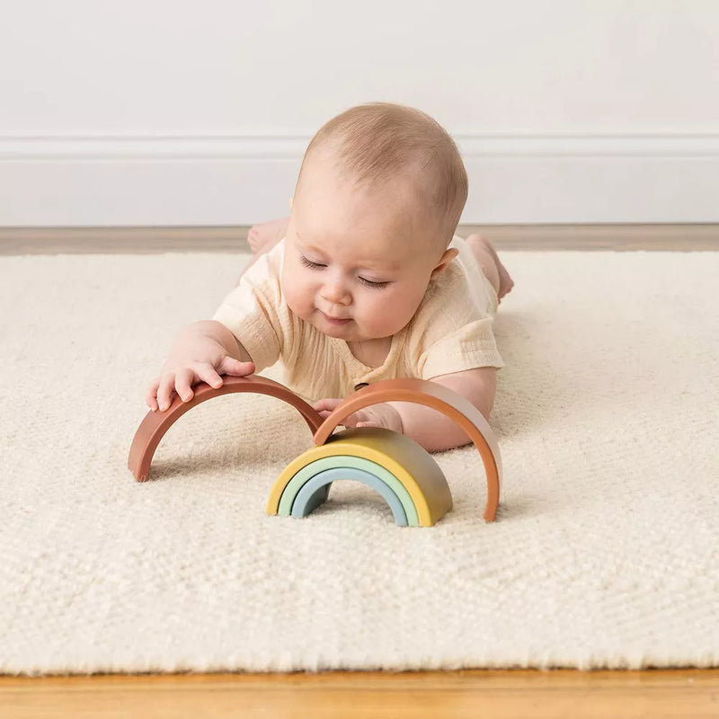 Baby plays with Itzy Ritzy Ritzy Rainbow Stacking Toy