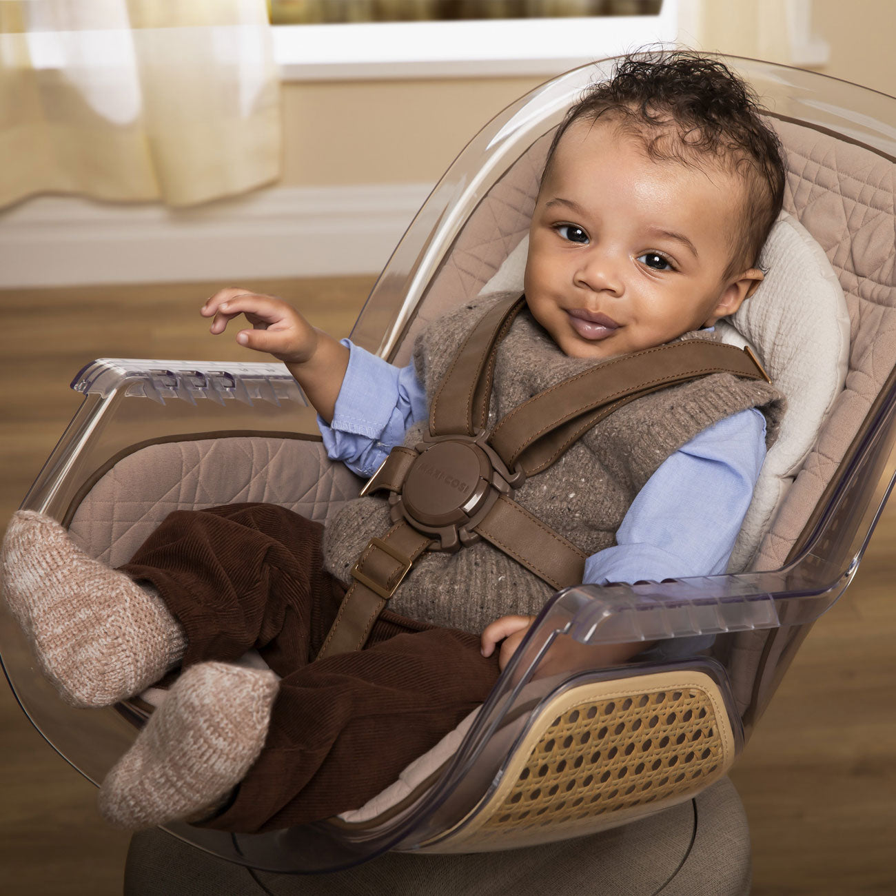 Baby sits in Maxi-Cosi Kiskadee 360 Rotating Highchair - Natural Heritage