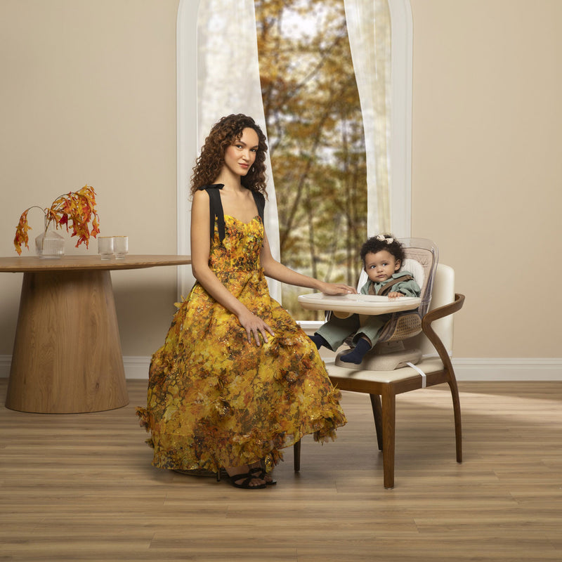 Mom sits in front of toddler sitting in Maxi-Cosi Kiskadee 360 Rotating Highchair - Natural Heritage