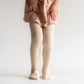 Little girl wearing Little Stocking Co Cable Knit Tights - Vanilla