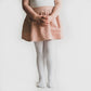 Little girl wearing Little Stocking Co Cable Knit Tights - White