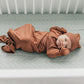 Baby lying on Mebie Baby Muslin Crib Sheet- Desert Sage