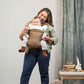Mom carries baby forward facing in Nuna CUDL Luxe Carrier - Canyon