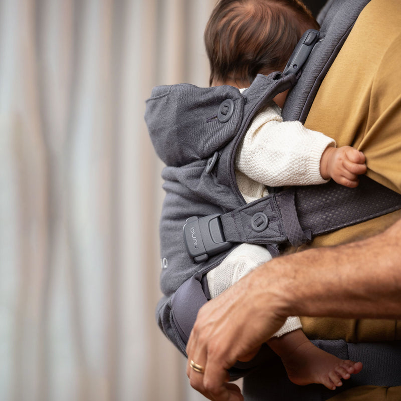 Dad carries newborn in Nuna CUDL Luxe Carrier - Dusk