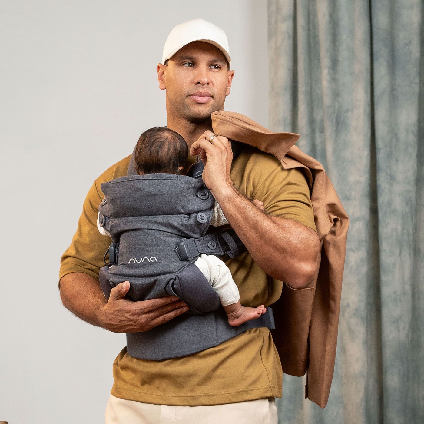 Dad carries newborn in Nuna CUDL Luxe Carrier - Dusk