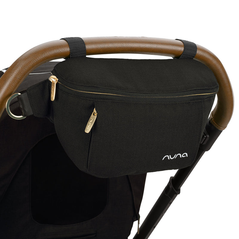Nuna Sling Bag - Caviar attached to handlebar of stroller