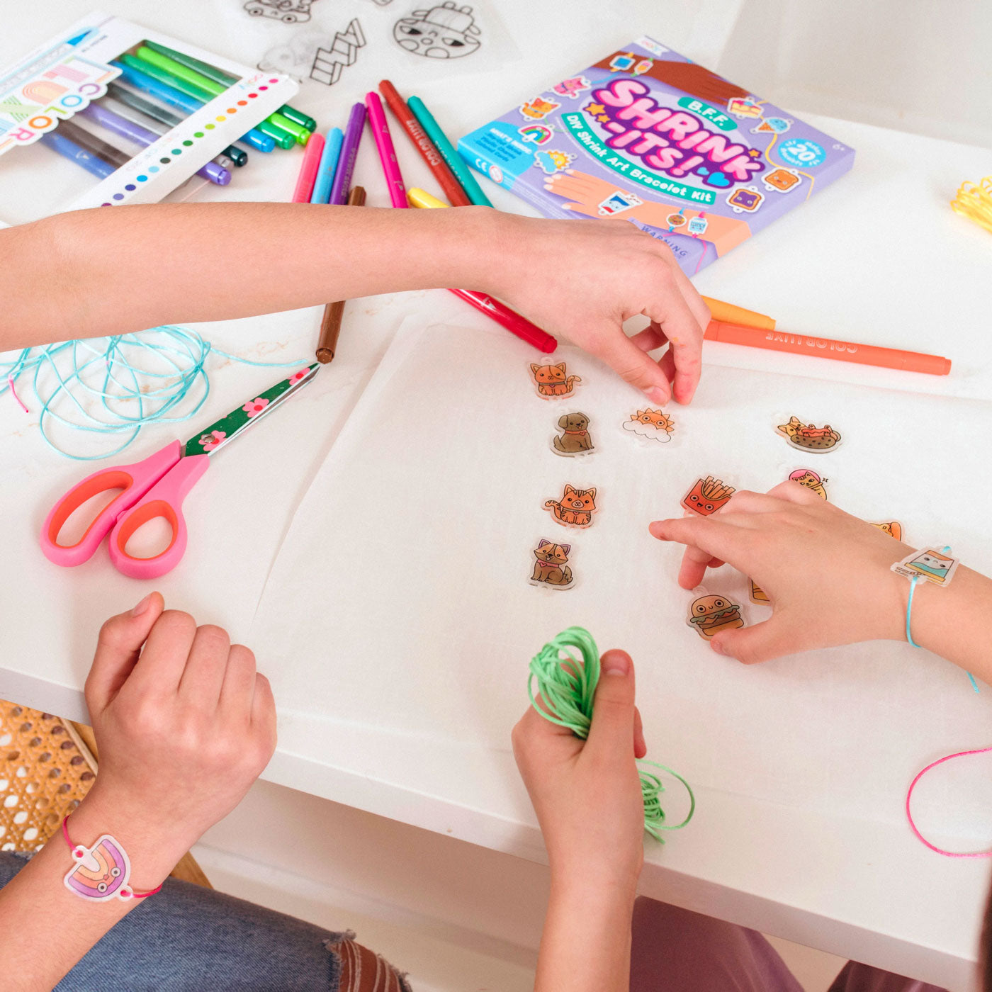 Girls making OOLY Shrink-its! DIY Shrink Art Kit - BFF Bracelet