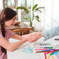 Girl putting bracelet on mother from OOLY Shrink-its! DIY Shrink Art Kit - BFF Bracelet