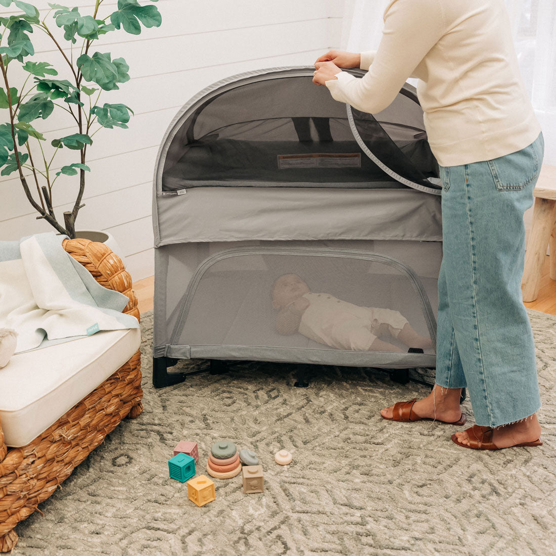 Mom unzips UPPAbaby REMI Playard Canopy