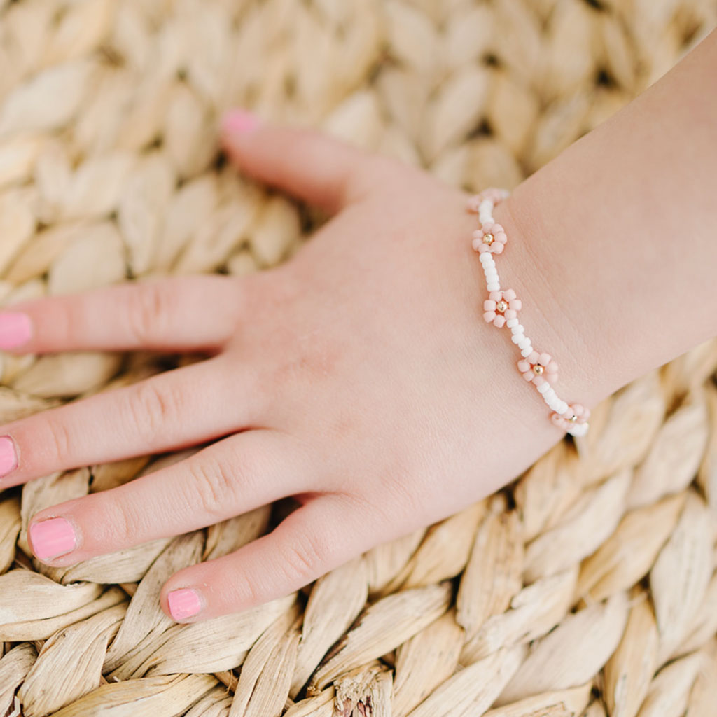Little girl wears Joyful Bead Company Petal Pink Flower Bracelet - Gold