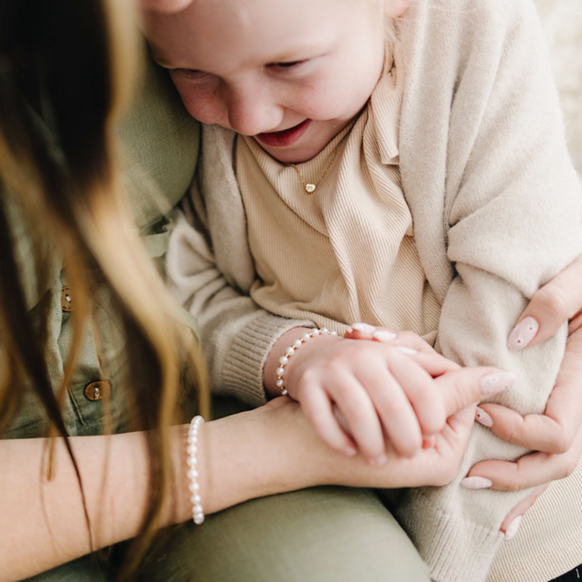 Little girl and mom wearing matching Joyful Bead Company Fancy Pearl Bracelet