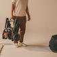 Man carries stroller frame of Tavo Maeve + Roscoe 3-in-1 Pet Protection System - Medium Flex - Onyx