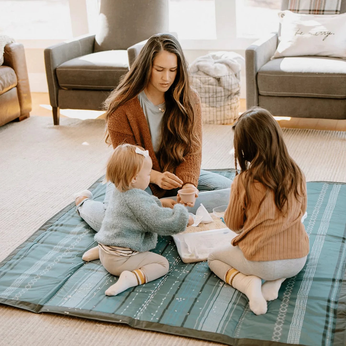 mom and kids sit on Little Unicorn Outdoor Blanket - 5x10